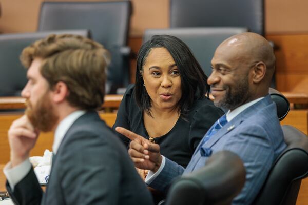 District Attorney Fani Willis (center) reacts to proceedings at Fulton County Superior Court on Thursday, July 21, 2022. State Sen. Burt Jones filed a motion to remove Willis from the Fulton County Trump investigation because she held a fundraiser for Jones’ Democratic opponent Charlie Bailey. (Arvin Temkar / arvin.temkar@ajc.com)