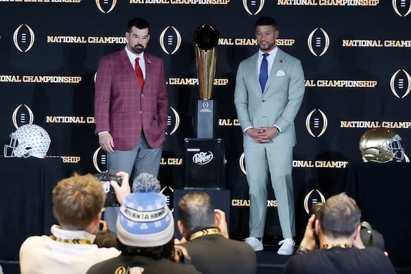 Ohio State head coach Ryan Day (left) and Notre Dame head coach Marcus Freeman pose for a photo following a news conference Saturday in Atlanta.