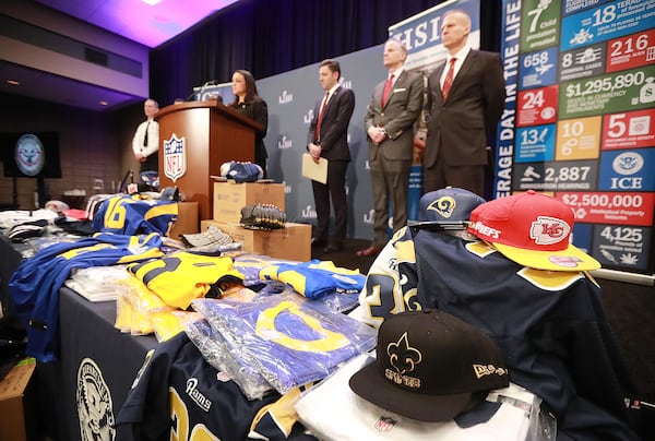 Fake NFL merchandise covers a table as the National Football League and law enforcement agencies announce the latest results of seizures of counterfeit game-related merchandise and tickets during a press conference at the Georgia World Congress Center on Thursday, Jan. 31, 2019, in Atlanta. Curtis Compton/ccompton@ajc.com