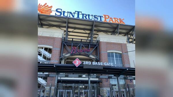 Crews started the process of removing the SunTrust Park signs from the Braves' stadium ahead of a name-change.