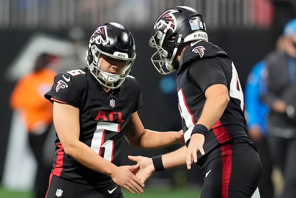 Atlanta Falcons place-kicker Younghoe Koo (6) celebrates with teammate during the second half of an NFL football game against the Los Angeles Chargers on Sunday, Dec. 1, 2024 in Atlanta. (AP Photo/Mike Stewart)