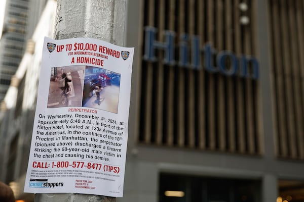 A reward poster hangs on a light pole outside the Hilton Hotel in midtown Manhattan where Brian Thompson, the CEO of UnitedHealthcare, was fatally shot ,Wednesday, Dec. 4, 2024, in New York. (AP Photo/Stefan Jeremiah)