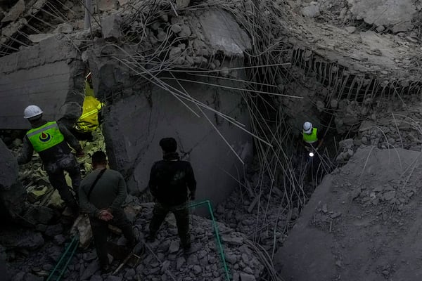 Rescue workers search for victims at a house hit in an Israeli airstrike in Baalchmay village east of Beirut, Lebanon, Tuesday, Nov. 12, 2024. (AP Photo/Hassan Ammar)