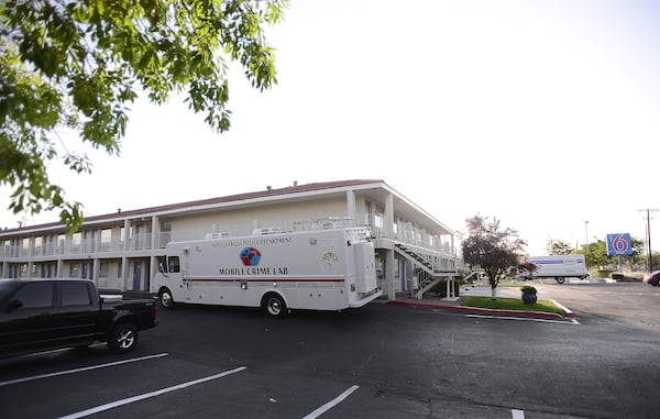 An Albuquerque Police Department mobile crime lab is seen July 1, 2015, after a shooting at the hotel left a man dead and another injured during what police say was an altercation between the two the night before at a Motel 6. 