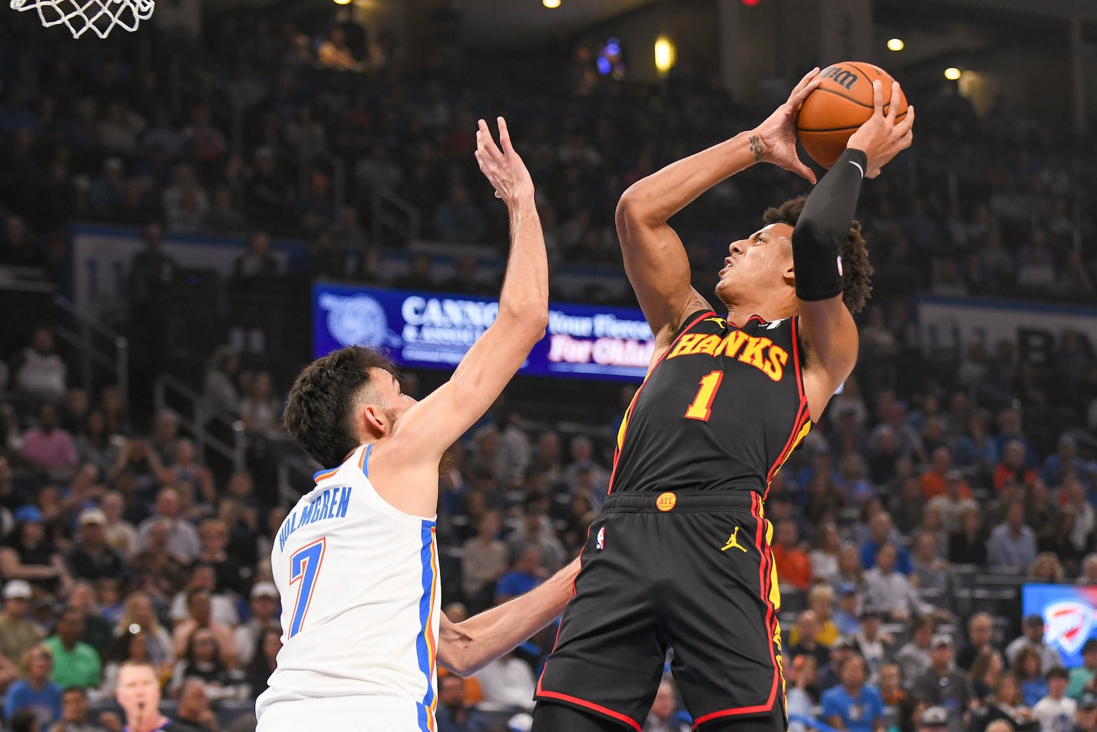 Atlanta Hawks forward Jalen Johnson (1) shoots over Oklahoma City Thunder forward Chet Holmgren (7) during the first half of an NBA basketball game, Sunday, Oct. 27, 2024, in Oklahoma City. (AP Photo/Kyle Phillips)