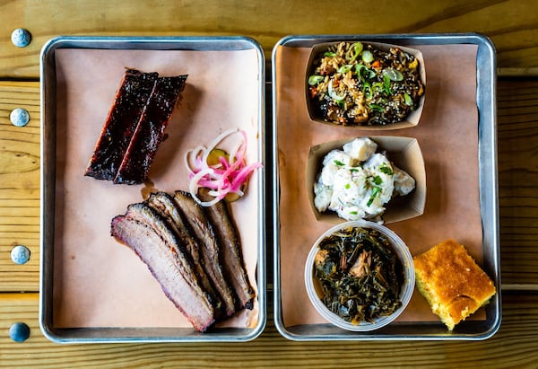 A two-meat plate of St. Louis-style pork ribs and beef brisket with three sides and cornbread.. The two-meat plate typically includes two sides. CONTRIBUTED BY HENRI HOLLIS