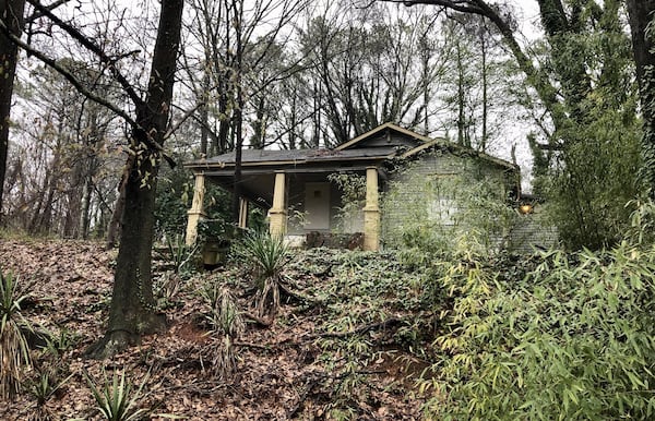 A boarded up home in the Carey Park neighborhood west of Midtown Atlanta sits in an area where two well-known players in Atlanta real estate planned a sweeping redevelopment. Those two speculators, Brock Built Homes President Steve Brock, and broker Gregory Todey, are now gripped in a legal battle with Brock claiming Todey defrauded him of his interests in distressed land near the future Westside Park at Bellwood Quarry. J. SCOTT TRUBEY/SCOTT.TRUBEY@AJC.COM