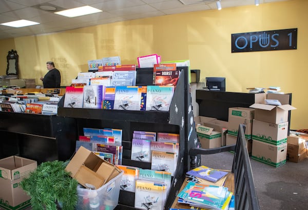 David Highsmith packs up Opus 1 Music in Decatur on Tuesday, January 16, 2024, closing the sheet music store that opened in 1971.  Highsmith has owned the spot in the strip with Cafe Lily for 22 years.  (Jenni Girtman for The Atlanta Journal-Constitution)