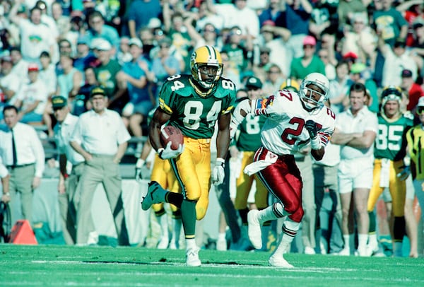 Green Bay Packers wide receiver Sterling Sharpe (84), chased by Phoenix Cardinals Jay Taylor, heads towards the goal line to score the first touchdown in their game in Tempe, Nov. 18, 1990.  (AP Photo/Jeff Kida)