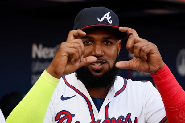 Braves designated hitter Marcell Ozuna auditions for a broadcasting gig prior to a July 2024 game.