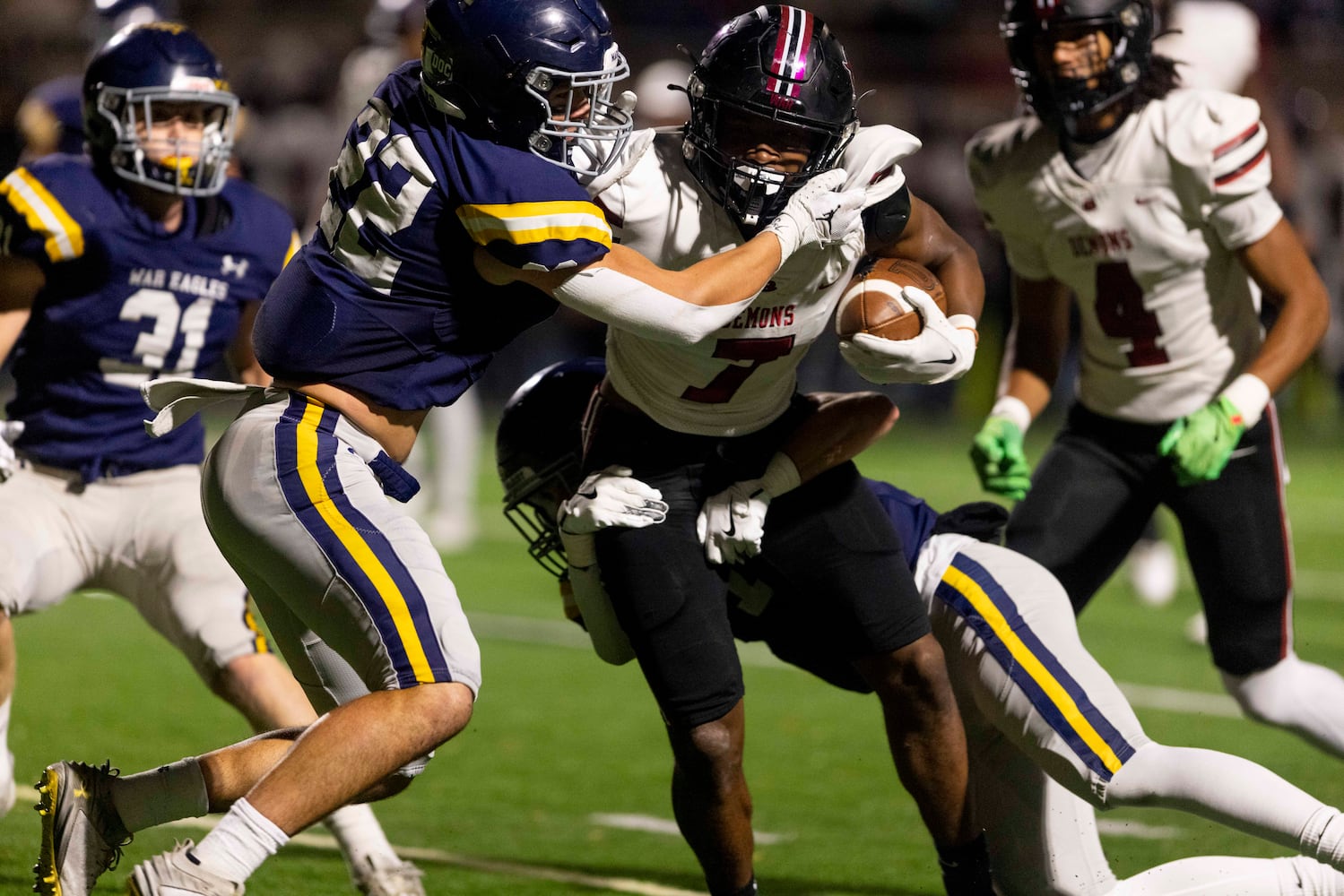 Warner Robins’ Damoni Cox (7) is wrapped up by the Marist defense during Friday's high school football state playoff game at Marist.  (Photo/Jenn Finch, AJC)