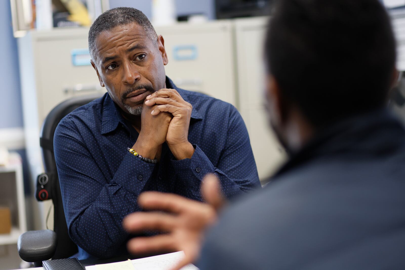 Greg Smith, left, from the Heres to Life organization listen to Juanteen speak during a meeting. Greg Smith and colleagues have found creative ways to reach the community to provide monkeypox vaccines.
 Miguel Martinez / miguel.martinezjimenez@ajc.com
 