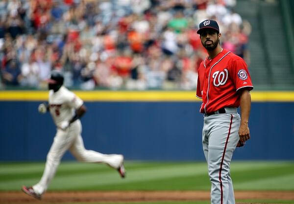 Washington Nationals starting pitcher Gio Gonzalez, right, looks toward home plate after giving up a two-run home run to Atlanta Braves' Justin Upton, left, in the first inning of a baseball game, Sunday, April 13, 2014, in Atlanta. (AP Photo/David Goldman) Gio Gonzalez contemplates another loss to Atlanta. (David Goldman/AP)