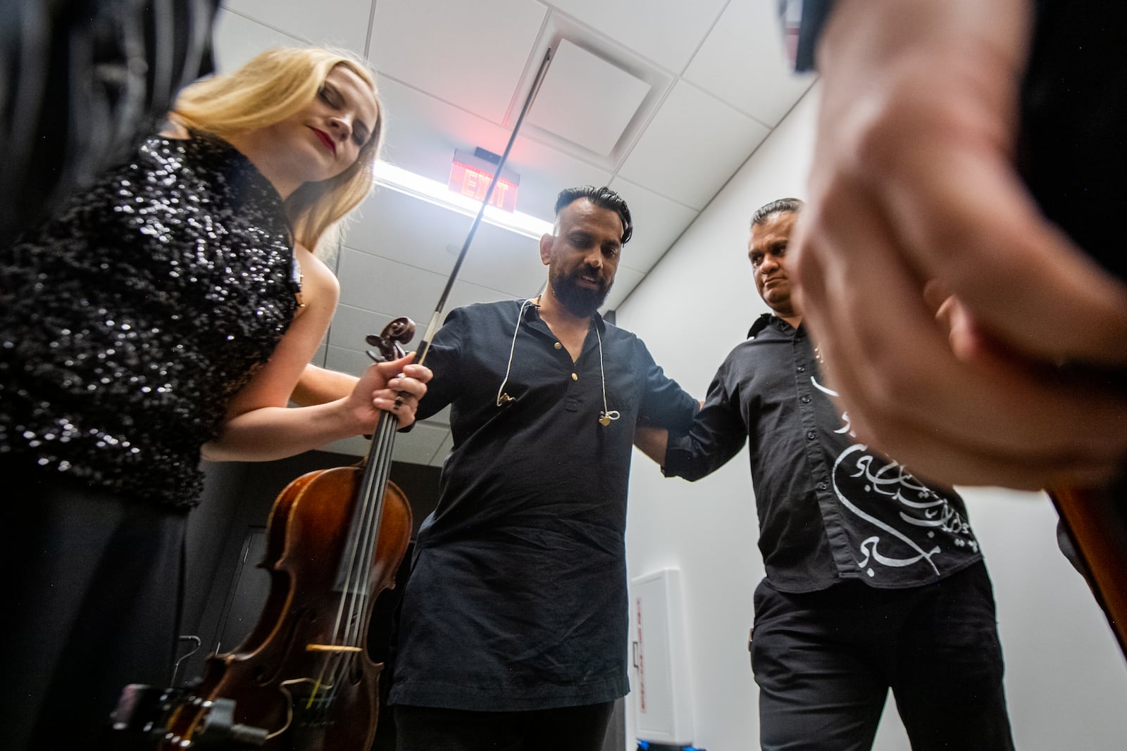 Band members cheer each other on before going on stage at a Surya Ensemble concert in Atlanta on Thursday, July 25, 2024.  Ziyu Julian Zhu/AJC