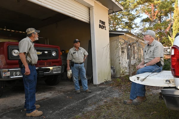 Glascock County Road Department employees (from left) Vance Black, 67, Roger Coxwell, 73, and Melvin Black, 71, take a break while working on replacing batteries on the only fire engine at the fire department next to the city hall in Edgehill, the smallest incorporated city in Georgia. They are all former Edgehill residents. (Hyosub Shin / Hyosub.Shin@ajc.com)