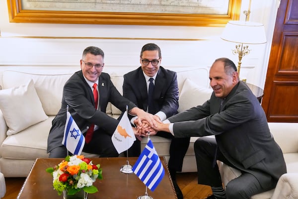 From left to right Israel's Foreign Minister Gideon Sa'ar, Cyprus' Foreign Minister Constantinos Kombos and Greece' Foreign minister Giorgos Gerapetritis shake hands during a trilateral meeting on energy cooperation in Athens, Greece, Thursday, March 13, 2025. (AP Photo/Petros Giannakouris)