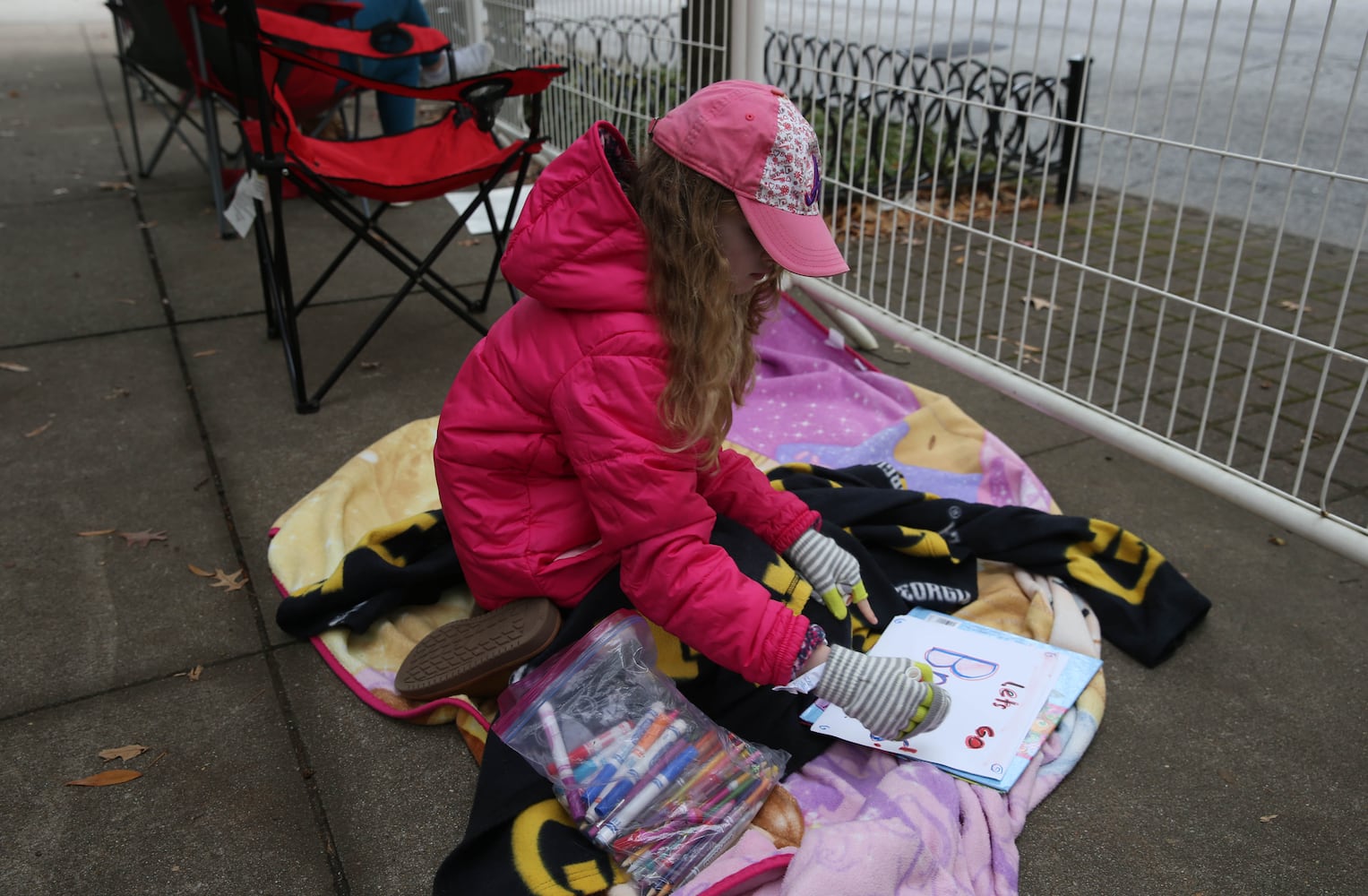 Lily Hardy, 8, from Hapeville, works on a sign before the Braves' World Series parade in Atlanta, Georgia, on Friday, Nov. 5, 2021. (Photo/Austin Steele for the Atlanta Journal Constitution)