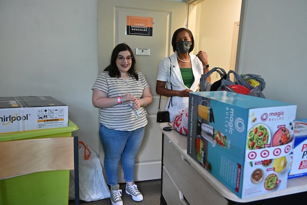 Isabel Rodriguez-Gonzalez, a sophomore at Georgia Gwinnett College in Lawrenceville, reacts as Jann Joseph (right), president of the college, visits her dormitory room on Tuesday, Aug. 3, 2021. Rodriguez-Gonzalez didn't live on campus last year and like many first-year students missed out on the college freshman experience. (Hyosub Shin / Hyosub.Shin@ajc.com)