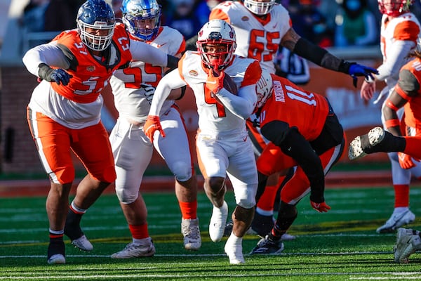 American Team running back TJ Pledger (4), of Utah, runs the ball 23 yards during the third quarter of an NCAA Senior Bowl college football game, Saturday, Feb. 5, 2022, in Mobile, Ala. (AP Photo/Butch Dill)