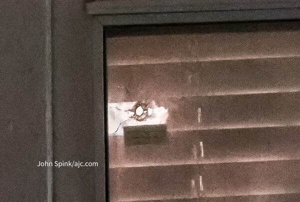 A bullet broke the blinds and a window to an apartment in DeKalb County after gunfire left one man dead Thursday.