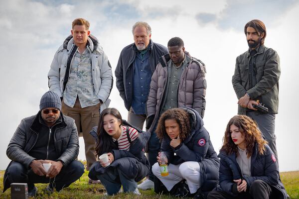 Filmmaker F. Gary Gray (far left) watches footage in between takes with the cast of "Lift" (continuing from left): Billy Magnussen, Yun Jee Kim, Vincent D’Onofrio, Kevin Hart, Gugu Mbatha-Raw, Úrsula Corberó and Viveik Kalra. Stefano Cristiano Montesi/Netflix