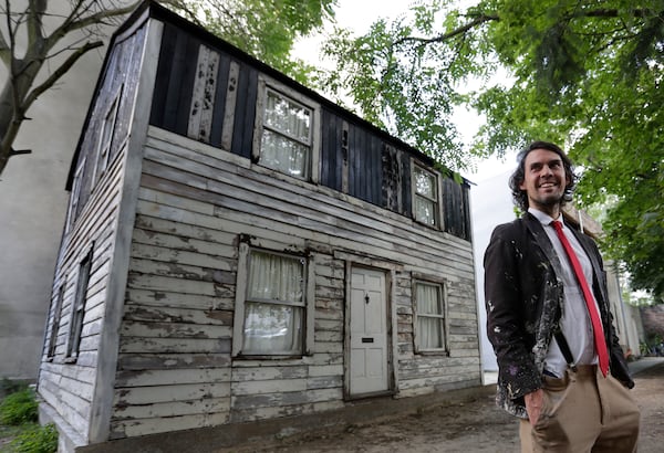 In this Wednesday, Aug. 23, 2017 photo American artist Ryan Mendoza poses during an interview with the Associated Press in front of the rebuilt house of Rosa Parks in Berlin. Parksâ house has been standing in the German capital for less than a year, but now Mendoza who saved it from destruction in Detroit says itâs time for it to return to the U.S. (AP Photo/Michael Sohn)