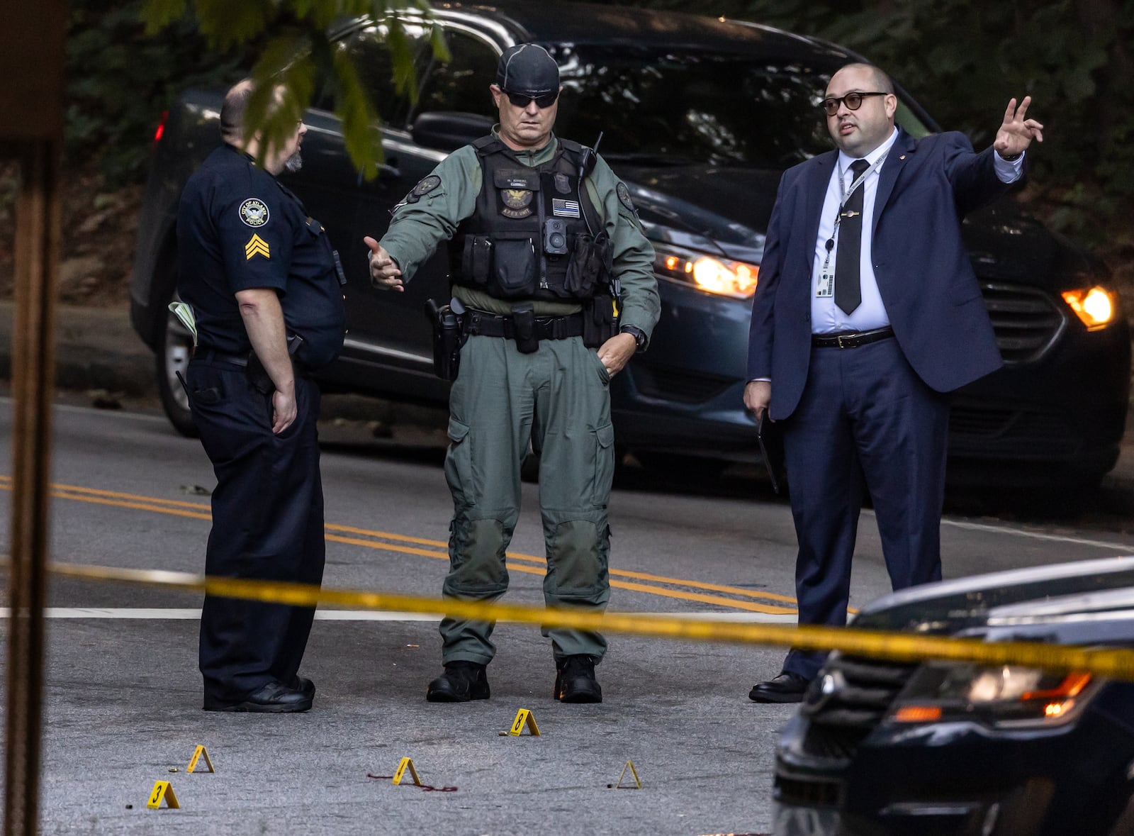 Atlanta police investigate the crime scene located at the Collier Drive and Harwell Road intersection in the Collier Heights neighborhood in Atlanta on Thursday morning, May 16, 2024. Police are trying to identify a woman who was found shot to death there. The woman had been shot at least three times. Officials have not released any information about suspects.(John Spink/AJC)