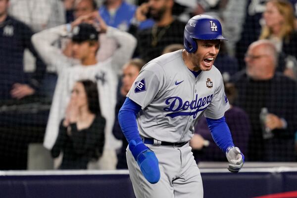 Los Angeles Dodgers' Freddie Freeman celebrates after scoring on a double by Teoscar Hernández during the fifth inning in Game 5 of the baseball World Series, Wednesday, Oct. 30, 2024, in New York. (AP Photo/Ashley Landis)