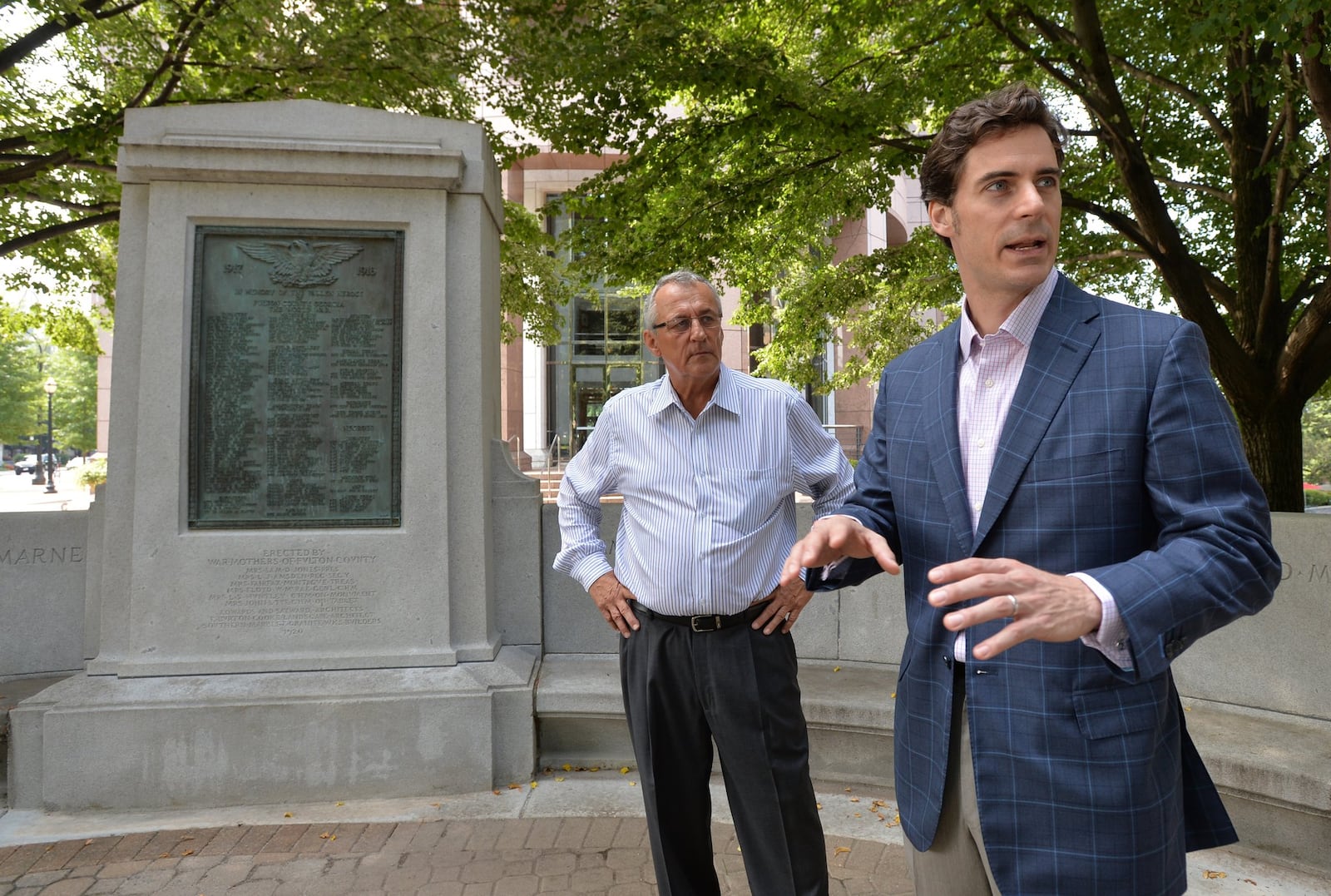 J.P. Boulee (right) and Ron Mountford check out the World War I monument at Pershing Point Park in Midtown. A lawyer, Boulee recruited his law firm to help refurbish the memorial. Mountford is a member of the American Legion Post No. 140, which also helped. Four organizations pitched in to restore the monument and spruce up the park. It is to be rededicated Monday, the 100th anniversary of that first world war. HYOSUB SHIN / HSHIN@AJC.COM