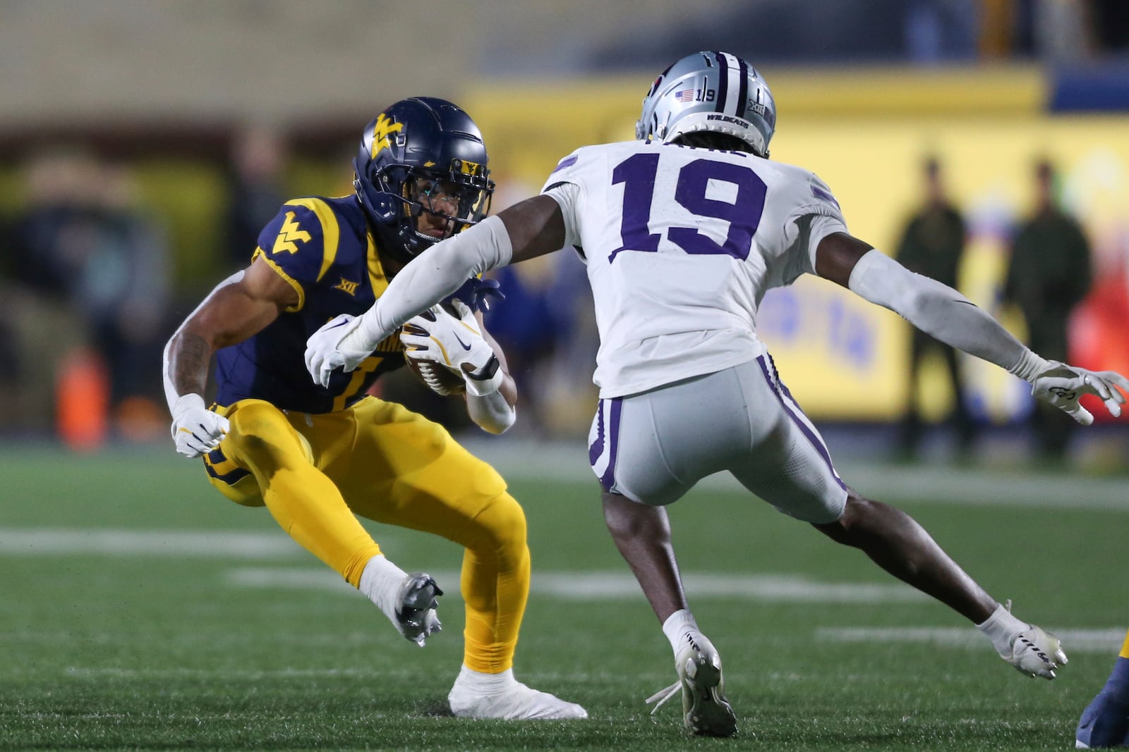 West Virginia running back Jahiem White (1) is tackled by Kansas State safety VJ Payne (19) during the first half of an NCAA college football game, Saturday, Oct. 19, 2024, in Morgantown, W.Va. (AP Photo/William Wotring)