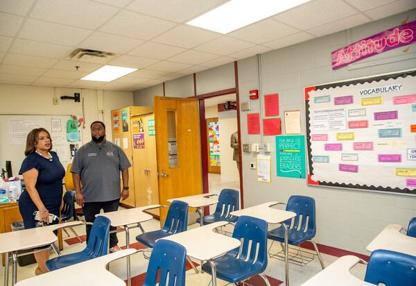 The DeKalb County School System has been assessing and fixing schools across the district throughout the summer. Vasanne S. Tinsley (left), the interim superintendent of the DeKalb County School District, is shown a recently painted accent wall in a classroom at Towers High School by the school’s Assistant Principal Joel Boyce (right) during a tour of the school updates on Wednesday, Aug. 31, 2022.  (Jenni Girtman for The Atlanta Journal-Constitution)