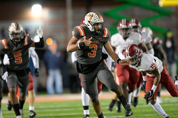 North Cobb quarterback Malachi Singleton (3) carries the ball for yardage against the Lowndes defense Dec. 4, 2020, in Kennesaw.