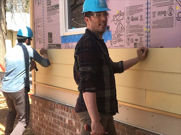 Drew and Jonathan Scott working on siding at a Habitat for Humanity site in Atlanta March 28, 2019.