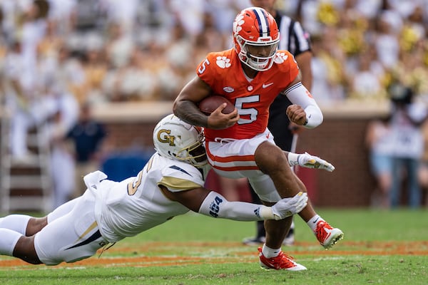 Clemson quarterback D.J. Uiagalelei (5) is brought down by defensive lineman Jared Ivey during the second quarter at Clemson Memorial Stadium on Saturday, Sept. 18, 2021, in Clemson, S.C. (Jacob Kupferman/Getty Images/TNS)