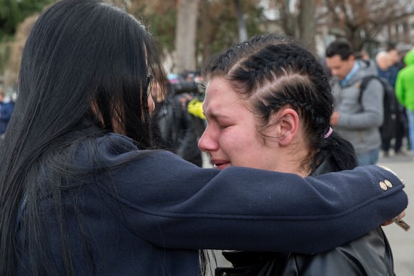 A girl cries as she wait in line to write condolence messages for the victims of a massive nightclub fire in the town of Kocani, North Macedonia, Monday, March 17, 2025. (AP Photo/Visar Kryeziu)