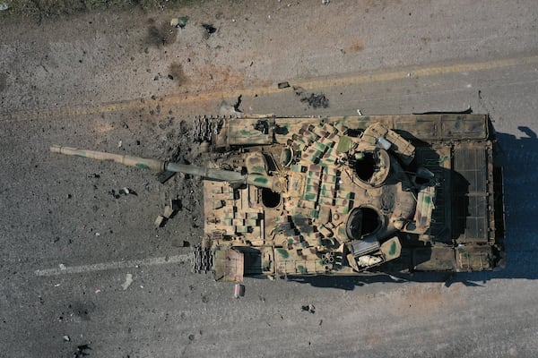 An abandoned Syrian army armoured vehicle sits on a road controlled by Syrian insurgents in the outskirts of Hama, Syria, Tuesday Dec. 3, 2024.(AP Photo/Ghaith Alsayed)