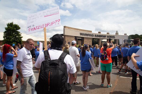 Standing with the Children, Georgia march protesters assemble at Woodstock Elementary before heading to the Elm Street Event Green in Woodstock Saturday, August 22, 2020. STEVE SCHAEFER FOR THE ATLANTA JOURNAL-CONSTITUTION