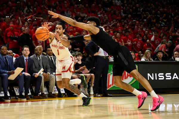 Maryland guard Rodney Rice (1) and Michigan State guard Jaden Akins battle for the ball during the second half of an NCAA college basketball game, Wednesday, Feb. 26, 2025, in College Park, Md. (AP Photo/Nick Wass)