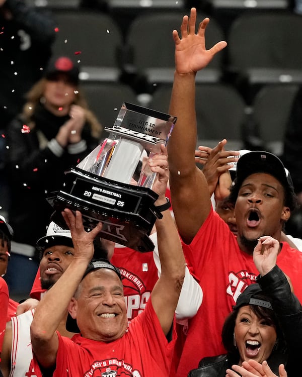 Houston head coach Kelvin Sampson lifts the trophy after winning an NCAA college basketball game against Arizona for the championship in the Big 12 Conference tournament, Saturday, March 15, 2025, in Kansas City, Mo. (AP Photo/Charlie Riedel)