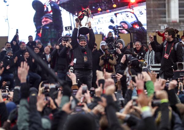 Gerardo Martino, head coach of the Atlanta United, raises the MLS Cup trophy during the victory rally at the Home Depot Backyard Lot.