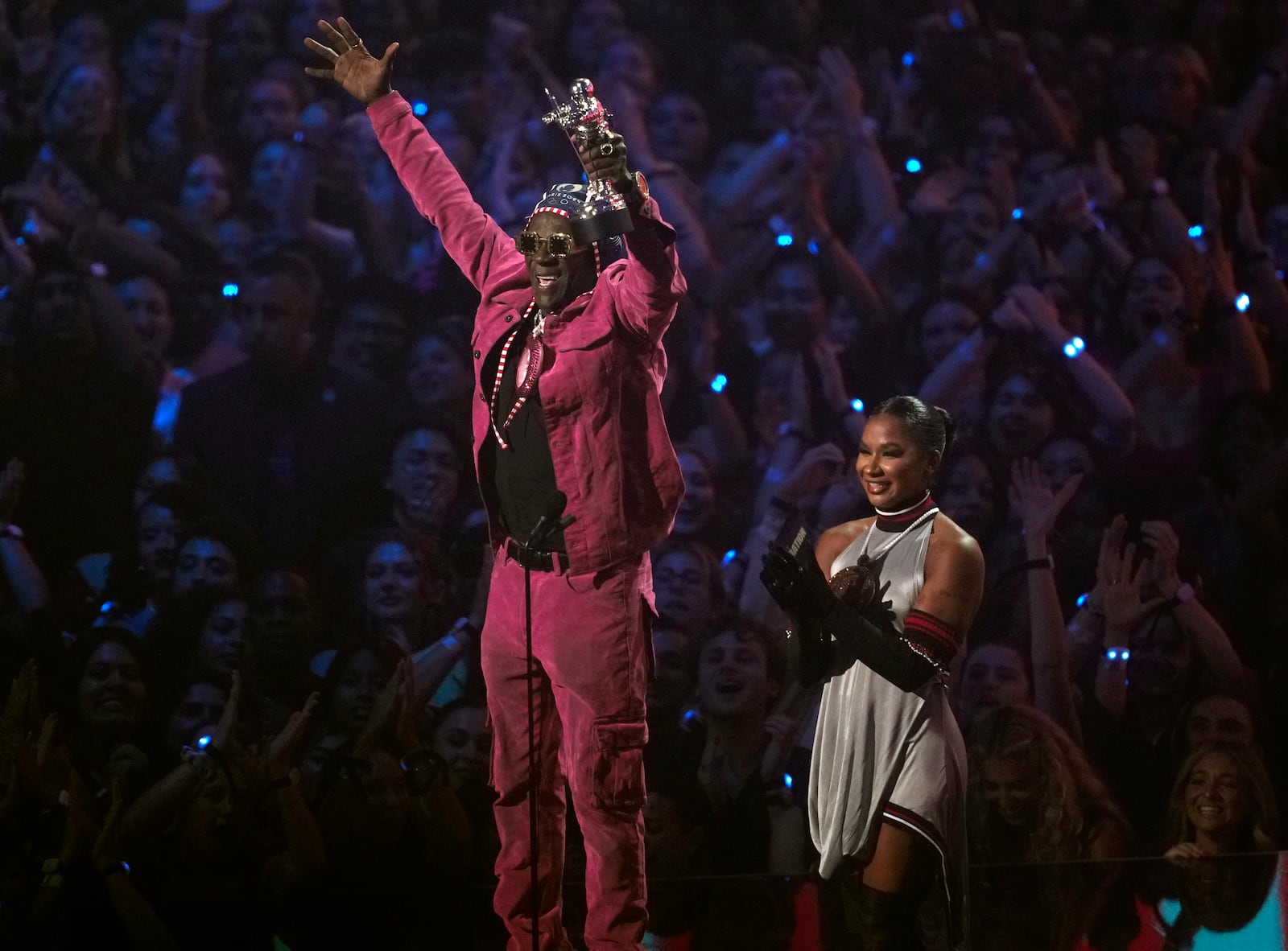 Flavor Flav, left, and Jordan Chiles present the award for best collaboration during the MTV Video Music Awards on Wednesday, Sept. 11, 2024, at UBS Arena in Elmont, N.Y. (Photo by Charles Sykes/Invision/AP)