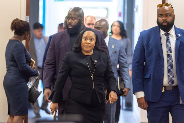 Fulton County District Attorney Fani Willis (center) enters the jury assembly room at Fulton County Courthouse in Atlanta on Tuesday, July 11, 2023. The latest Politically Georgia podcast examines the tough decisions ahead for Willis. (Arvin Temkar / arvin.temkar@ajc.com)