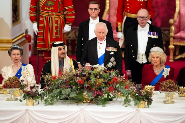 Britain's King Charles III, centre, and Queen Camilla, right, with the Emir of Qatar Sheikh Tamim bin Hamad Al Thani, second left, and Britain's Princess Anne, left, during a State Banquet at Buckingham Palace, in London, Tuesday, Dec. 3, 2024, during the state visit to the U.K. of the Emir of Qatar. (Jordan Pettitt/Pool Photo via AP)