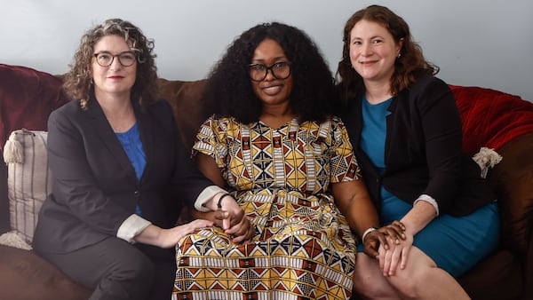 Atlanta Legal Aid client Faly Bangoura (center), was assisted by attorneys Mara Block (left) and Sarah Austin, who helped her divorce her abusive husband and gain custody of their four children. Natrice Miller/AJC