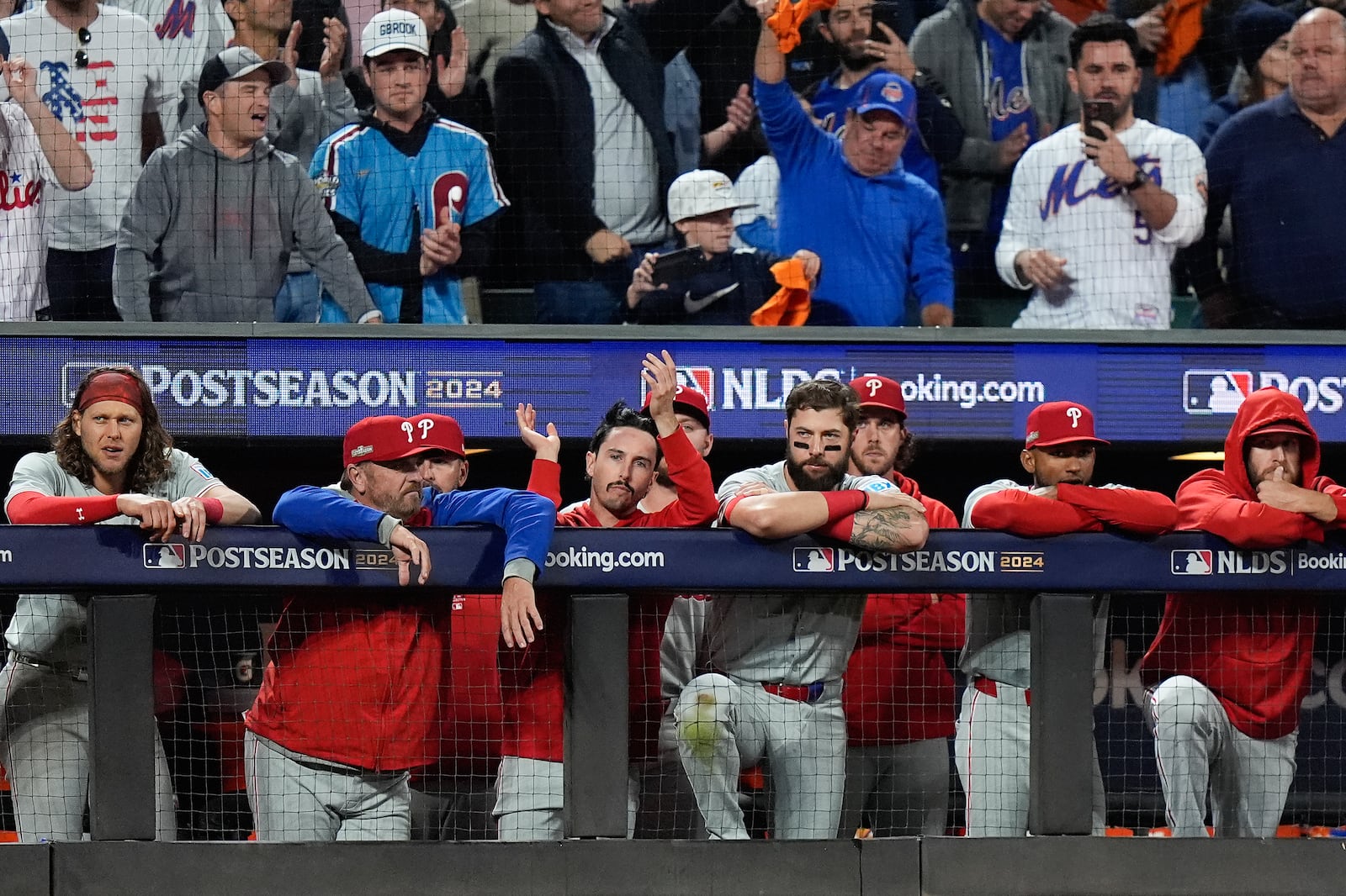 The Philadelphia Phillies watch play against the New York Mets in the ninth inning of Game 4 of the National League baseball playoff series, Wednesday, Oct. 9, 2024, in New York. (AP Photo/Frank Franklin II)