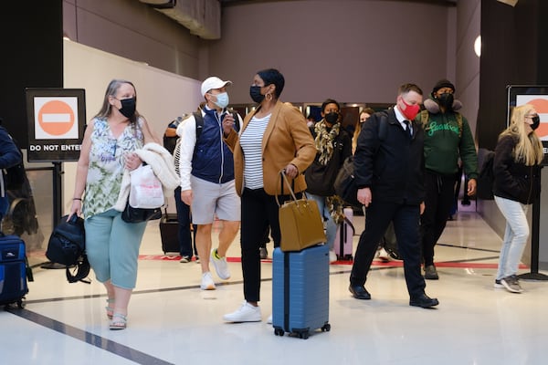 Travelers are seen at Hartsfield-Jackson airport in Atlanta on Friday, April 8, 2022.   (Arvin Temkar / arvin.temkar@ajc.com)