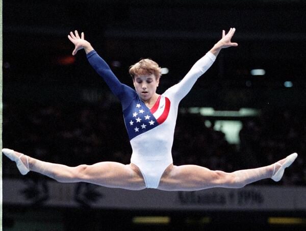 Kerri Strug of the U.S. women's gymnastics team on the balance beam Tuesday, July 23, 1996 at the Georgia World Congress Center during the 1996 Summer Olympic Games in Atlanta, Georgia. (AJC Staff Photo/Marlene Karas)