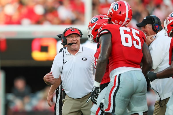 Georgia head coach Kirby Smart talks to Georgia offensive lineman Amarius Mims (65) and others during their game against UT-Martin at Sanford Stadium, Saturday, September 2, 2023, in Athens, Ga. (Jason Getz / Jason.Getz@ajc.com)