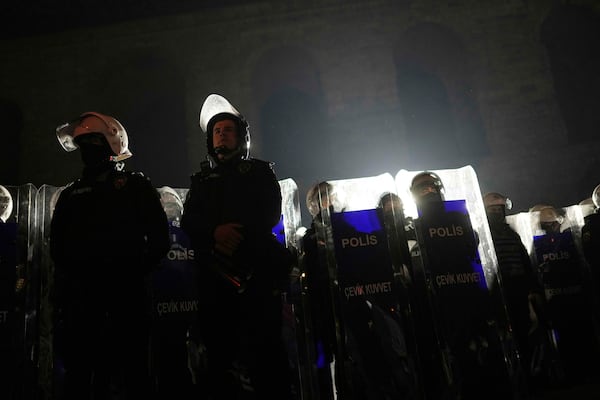 Riot police stand guard during a protest against the arrest of Istanbul's Mayor Ekrem Imamoglu, in Istanbul, Turkey, Saturday, March 22, 2025. (AP Photo/Francisco Seco)