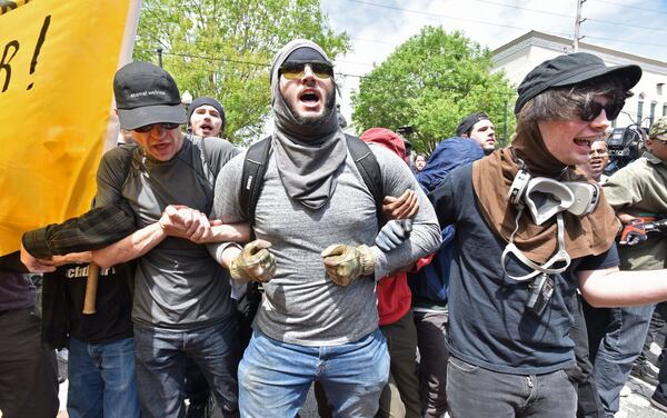 Anti racist protesters protest as the National Socialist Movement holds a rally at Greenville Street Park in downtown Newnan on Saturday, April 21, 2018. HYOSUB SHIN / HSHIN@AJC.COM